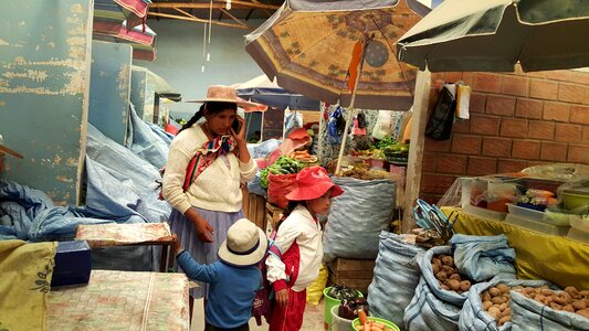 People selling and buying fruits at a market in the steets photo
