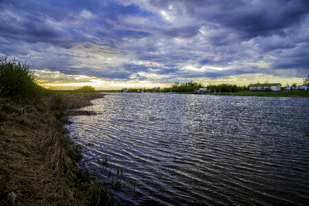 Sunset on the river under the clouds photo