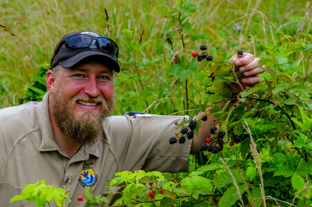 NCTC land management specialist with wild blackberry bushes with berries-1