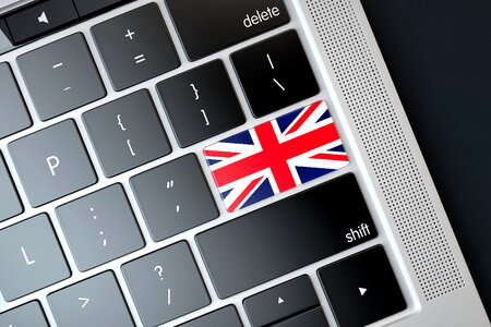 Flag of UK over computer keyboard. Technology concept photo