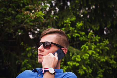Young Man Wearing Sunglasses Talking on the Phone photo