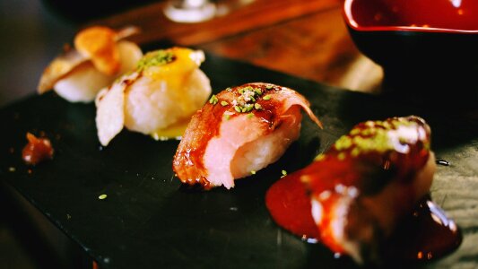 Various kinds of sushi served on black stone photo