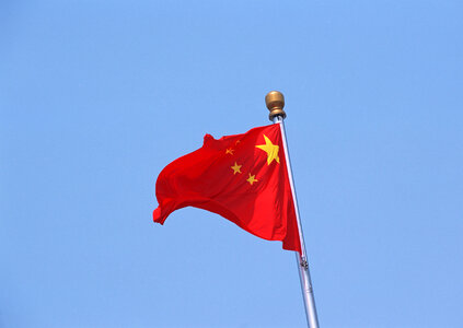 Chinese flag against a blue sky photo