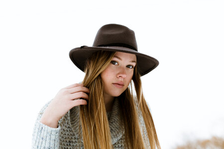 Girl Wearing a Knitted Sweater and a Dark Hat photo