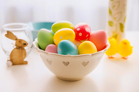 1 Happy Easter! A bowl full of Easter eggs. photo