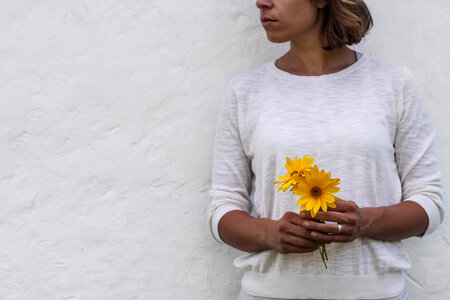 Woman Holding Yellow Flowers Free Photo photo