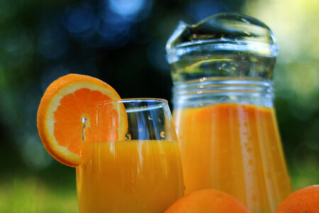 Glass and weighs detail with orange juice in nature photo