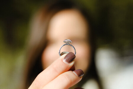 Woman Holding Engagement Ring in her Hand photo