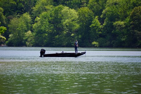 fisherman in a boat floating on the river photo