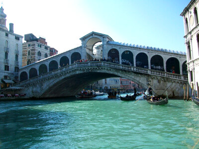 Venice Rialto bridge with gondola in Italy photo