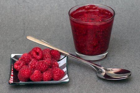 Still life raspberry puree spoons photo