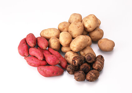 Lots of potatoes,taro, and red and golden sweet potatoes photo