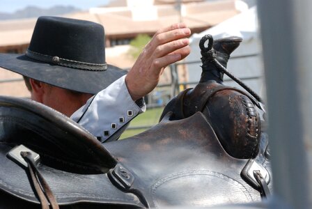 Cowboy hat hand saddle