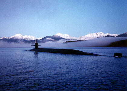 Submarine surfacing with mountains in the landscape