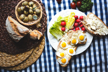 Easter breakfast of fried quail eggs on bread with butter photo