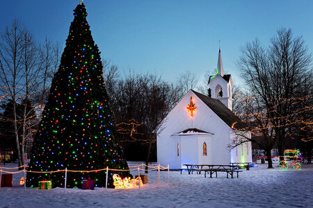 Lights and decorations and tree and church at Christmas photo