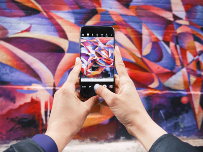Hands Holding Smartphone Photographing Street Art photo