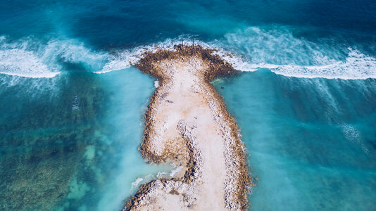 Ocean Waves crashing on small island aerial view photo