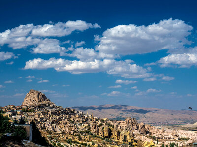 Landscape with houses in stones under sky and clouds in Cappadocia, Turkey photo