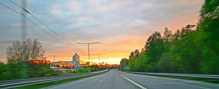 Highway and road into the sunset in town photo