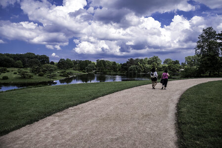 People walking on the path under the clouds landscape