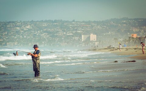 Man Fishing Fisherman Hat Beach Waves Sea photo