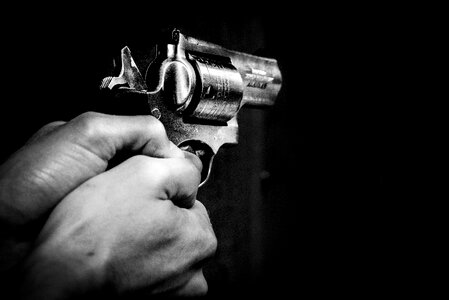 Man shooting revolver gun photo