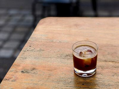 Cold coffee americano with ice cube on a wooden table photo