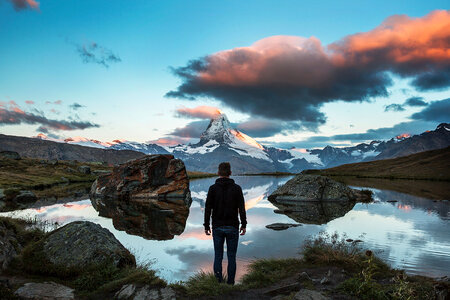 Person Looking at Beautiful lake and mountains landscape in Switzerland photo