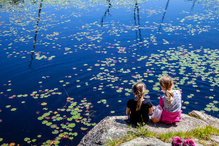 Girls enjoying a frog pond photo