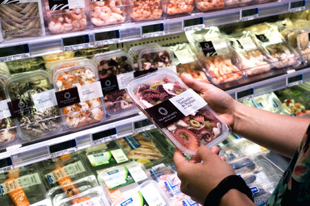 Woman buying seafood in grocery store