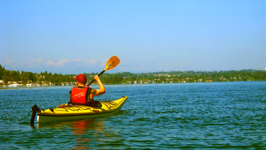 Canoer paddling on a lake photo