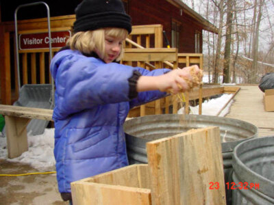 Young girl makes bird house