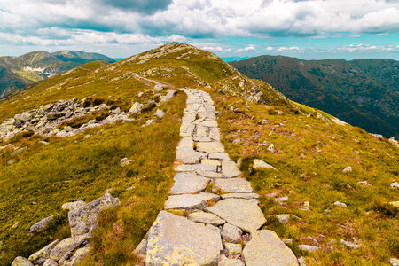 Beautiful landscape with a lane between rocky mountains photo