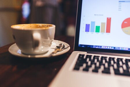 MacBook, Charts and Coffee photo