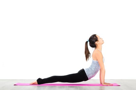Side view of woman doing upward dog yoga pose photo