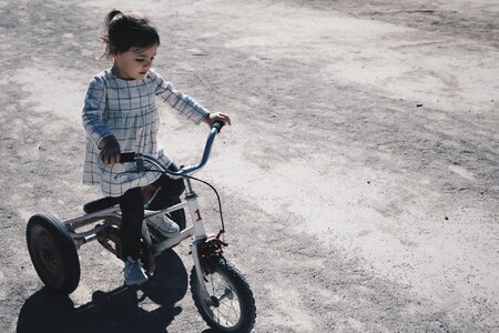 A Little Girl Riding a Tricycle Bike photo