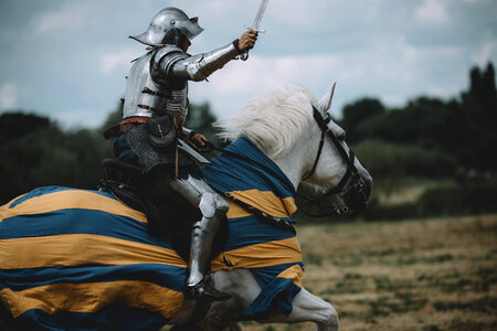 Knight Riding a Horse with Sword in His Hands photo