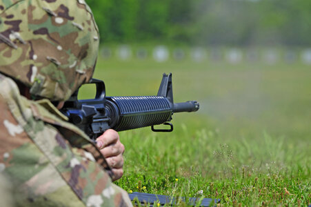 soldier aiming machine gun at firing range. photo