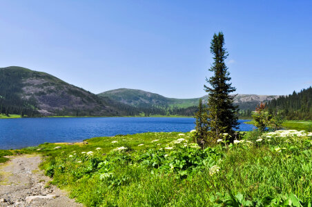 Lake, hills, and field landscape in Russia photo
