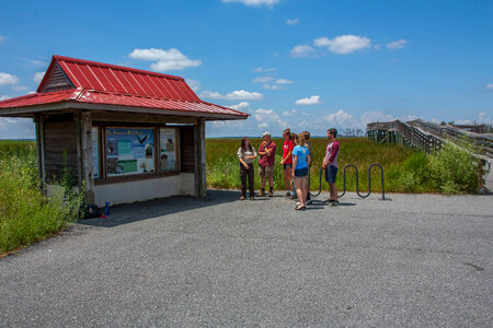 FWS staff talks to group of high school students at kiosk