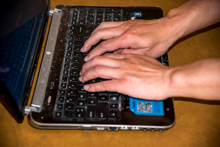 Hands Typing on Laptop