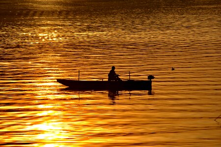 Boat fisherman golden glow photo