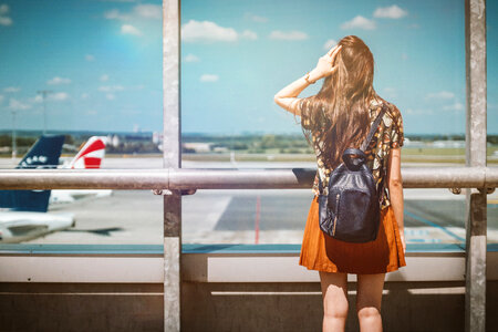 Vacation is beginning. Young female passenger at the airport. photo