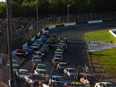 Many cars racing on a track photo