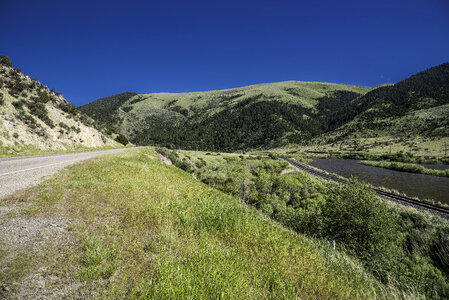 Hills, road, landscape, and river in Montana photo