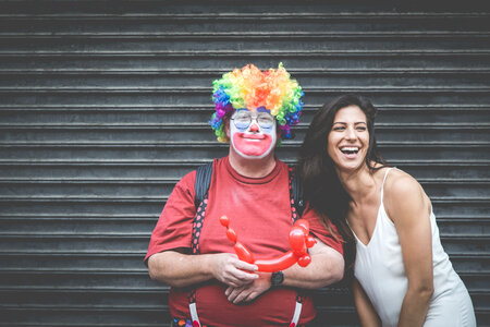 Man Dressed up as a Clown with a Laughing Woman photo