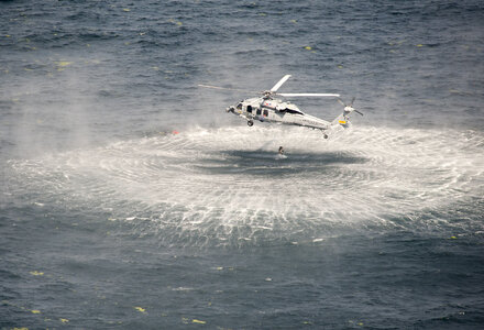 Naval Air Crewman jumps from an MH-60S Sea Hawk helicopte