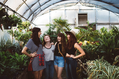 Group of Young Girls Laughing in a Greenhouse photo