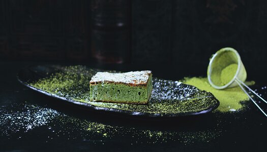 Japanese Matcha Green Tea Cheesecake on Black Plate, Healthy Dessert photo